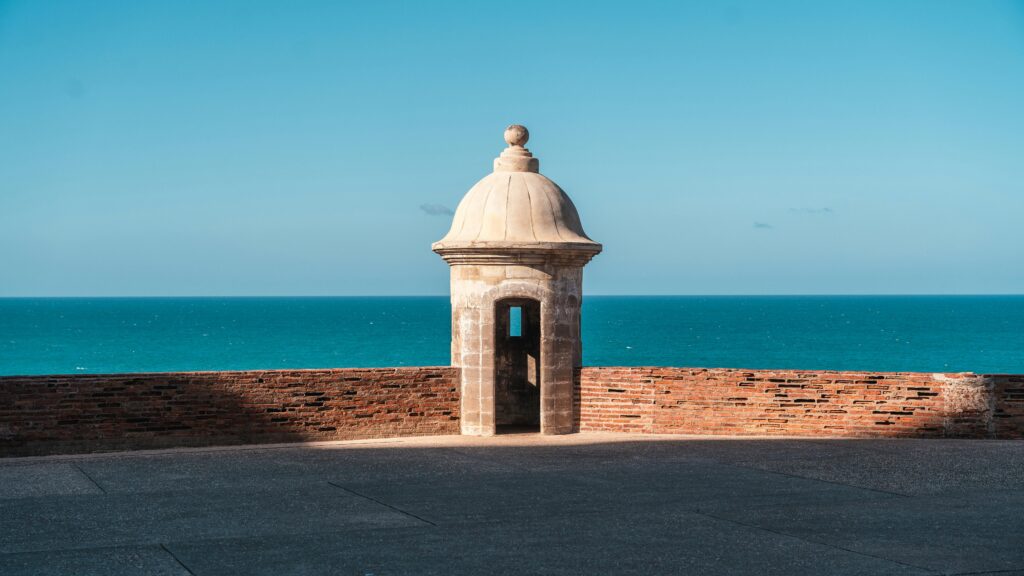 Historic guard tower with ocean view, showcasing a blend of architecture and nature.
